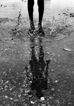 time-lapse photography of person stomping feet on water