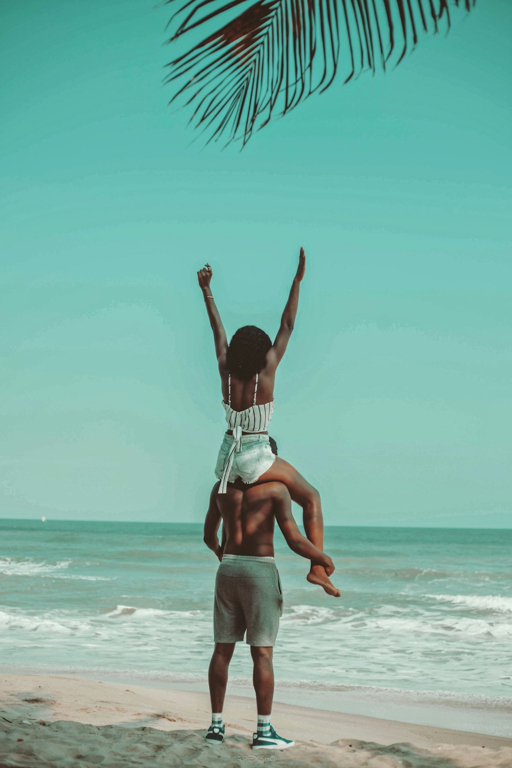 couple sits on the seashore