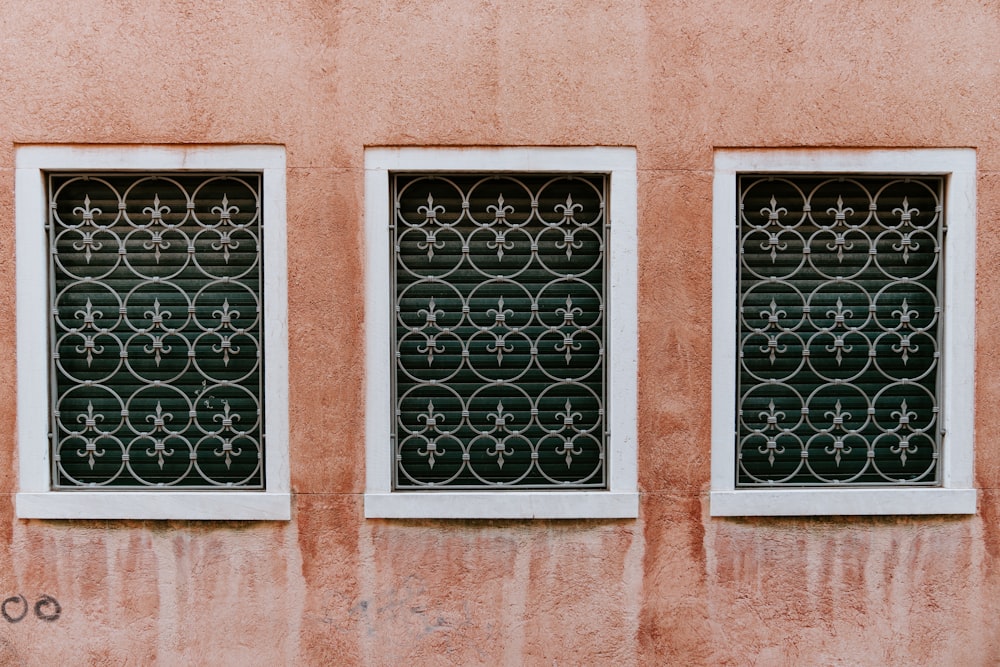 three white framed and window grills