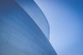low-angle photography of blue glass walled building during daytime