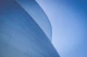low-angle photography of blue glass walled building during daytime