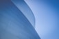 low-angle photography of blue glass walled building during daytime