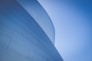 low-angle photography of blue glass walled building during daytime