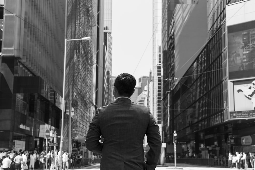 man in suit walking between buildings