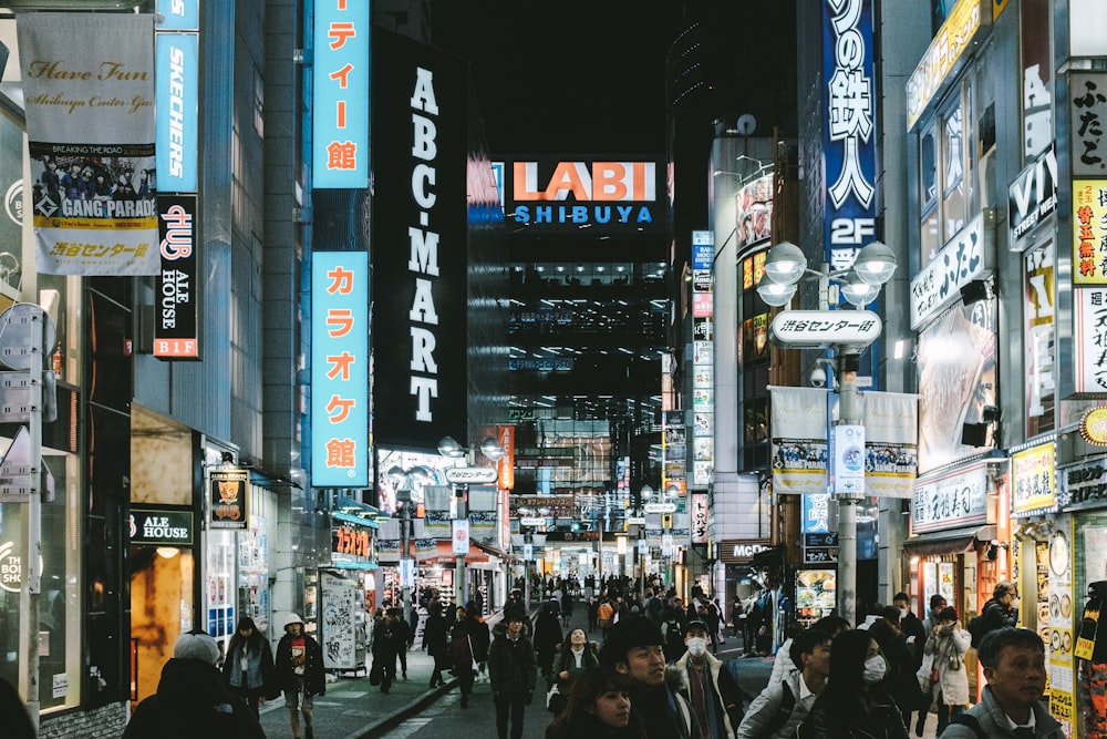 people walking between buildings at night