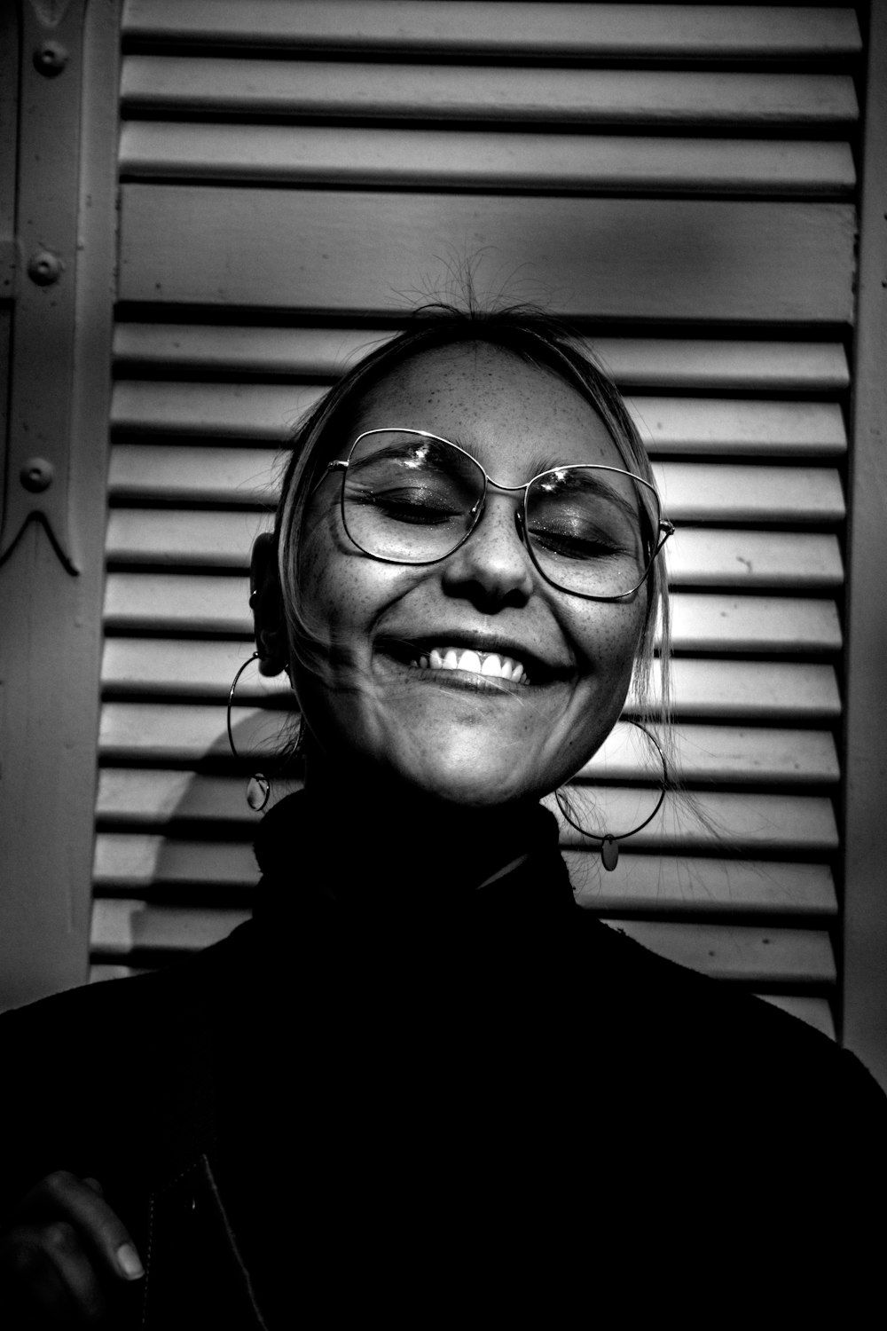 grayscale photography of smiling woman wearing turtle-neck top
