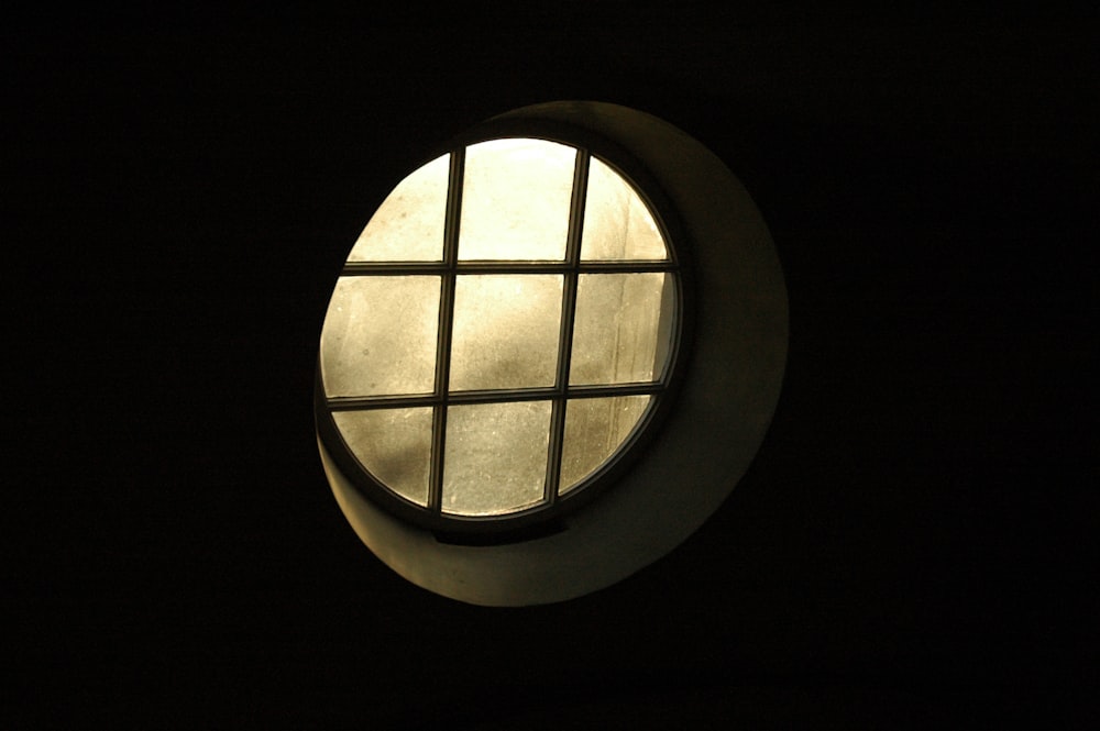a round window in a dark room at night