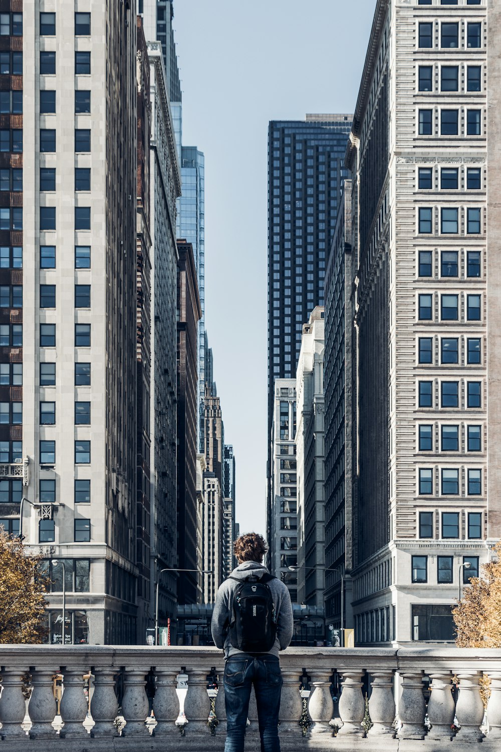 man standing beside rail during daytime