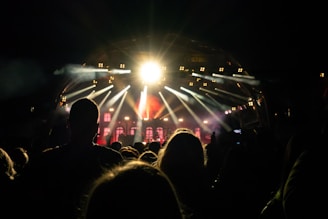A stage setup with lights and a crowd eagerly waiting for a performance.