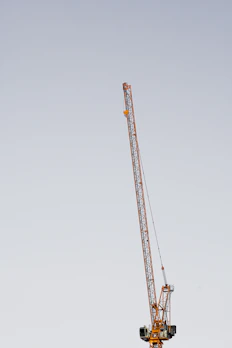 Aerial lift platform extended against a clear sky, highlighting sturdy metal components.