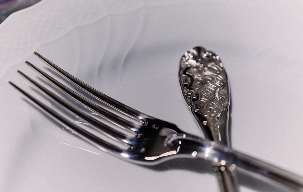 silver fork on white plate