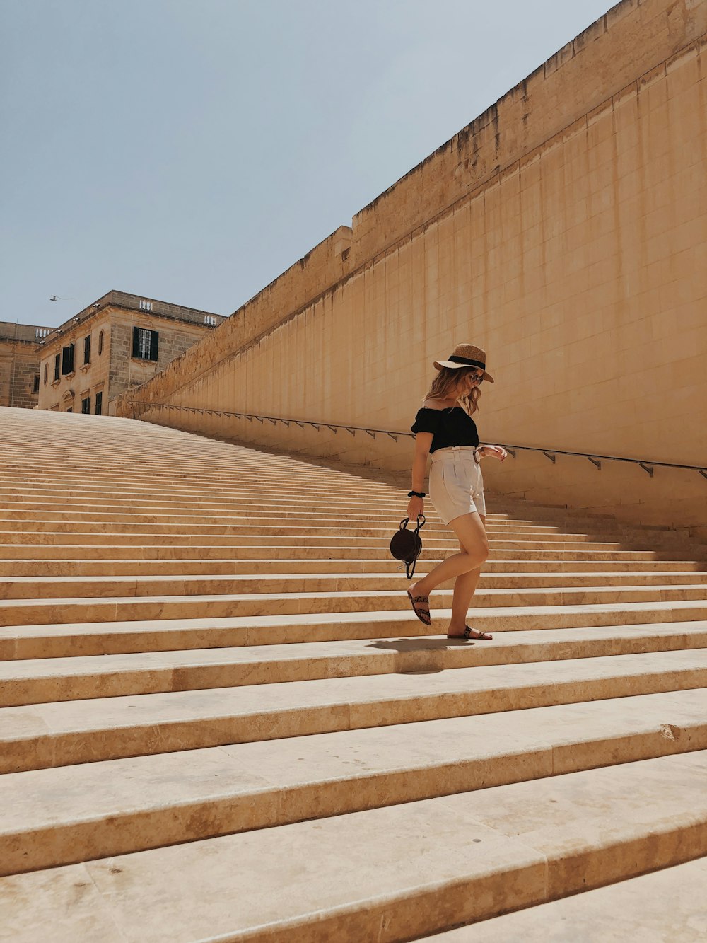 woman walking on stair during daytime