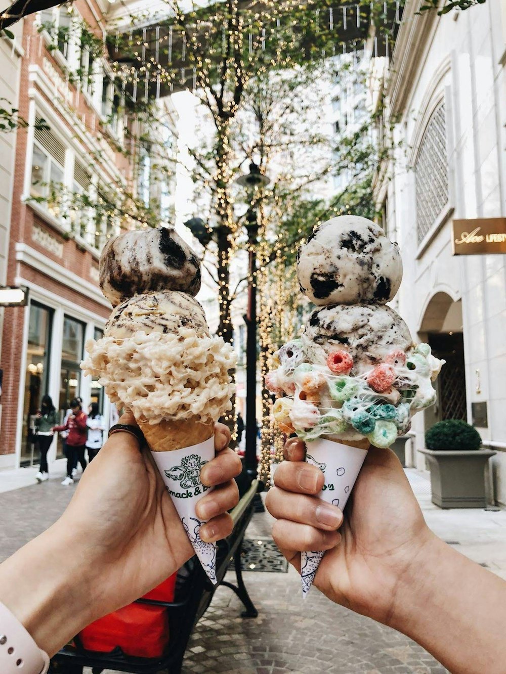 two person holding assorted-flavor ice creams