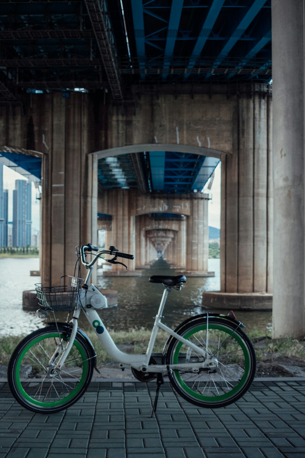 white and black city bike parked beside brown brick building