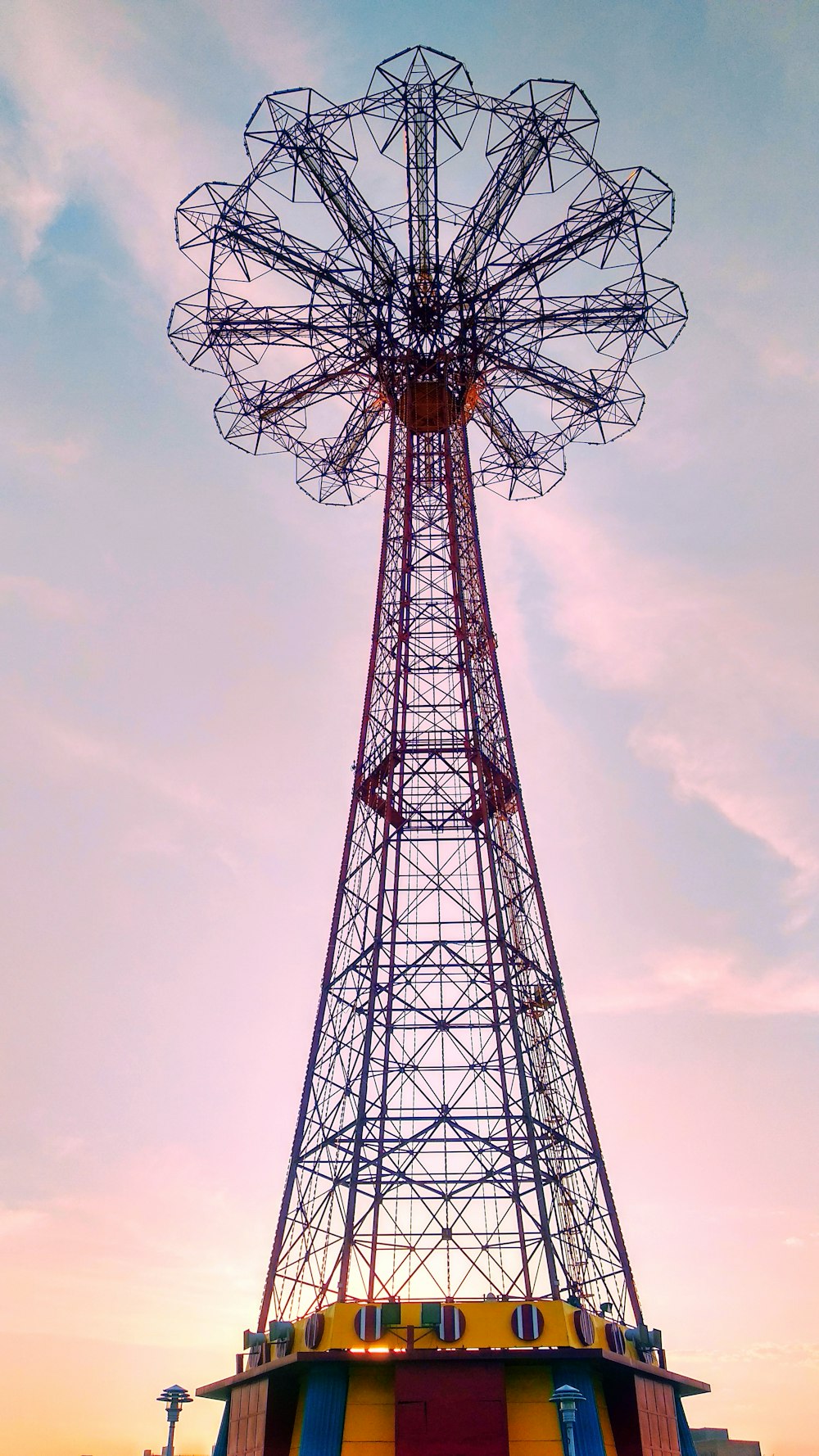 black and red ferris wheel at golden hour