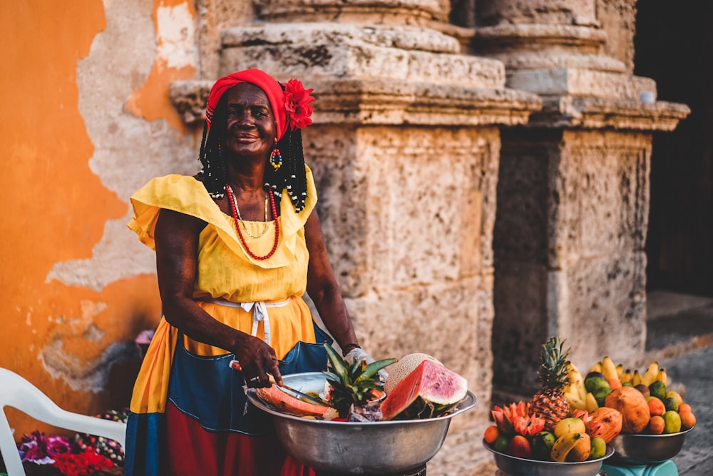 standing woman wearing yellow dress during daytime