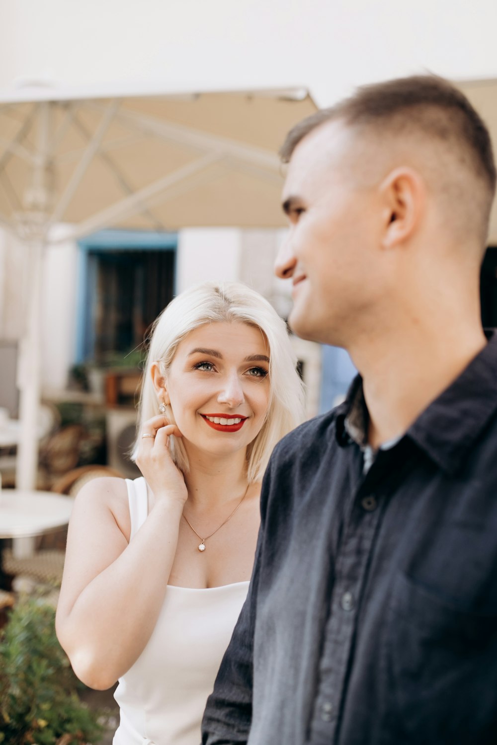 man wearing black dress shirt near woman wearing white top