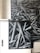 A black and white photograph featuring a complex pattern of overlapping cylindrical shapes that resemble intertwined pipes or metal beams. The artwork is applied to a cabinet set against a brick wall, and the image extends onto the wall as a mural.