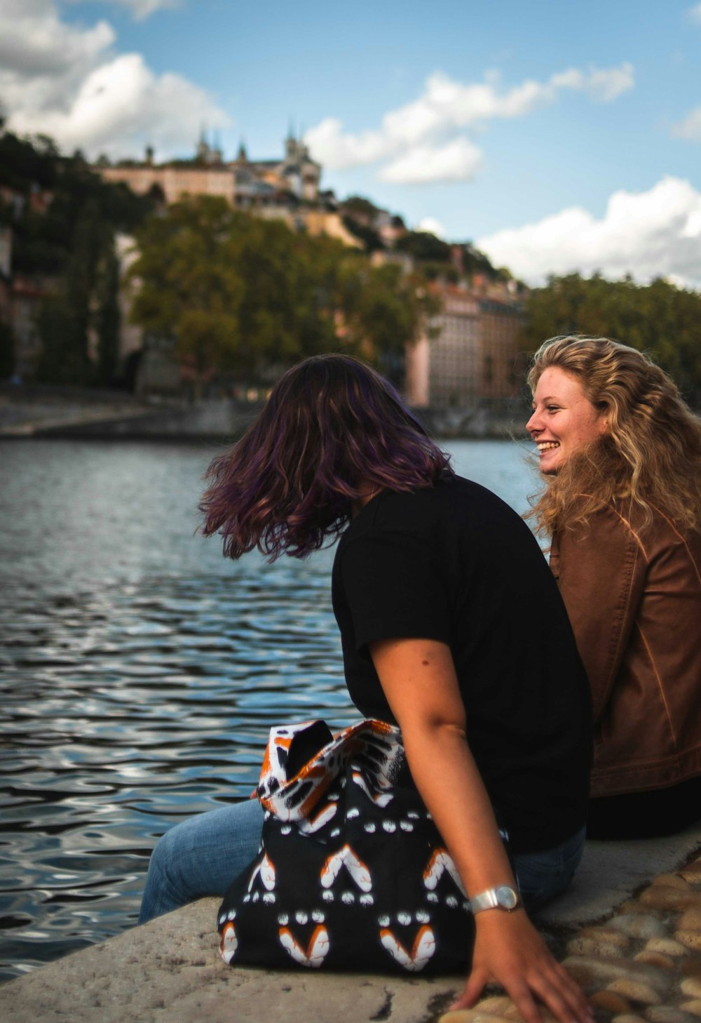 two women sitting on concrete floor