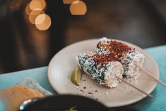 A vibrant street stand selling traditional Mexican elotes and esquites with colorful decorations.
