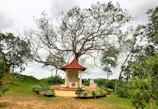 A peaceful sunset over a small shrine where families gather to reflect and pray.