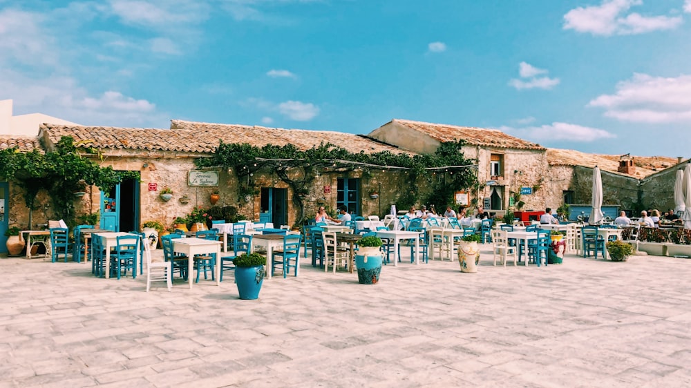 empty white and blue table and chairs on white sand