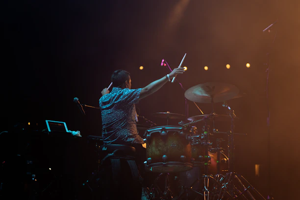 A professional drummer performing at an event with Drumeria equipment.