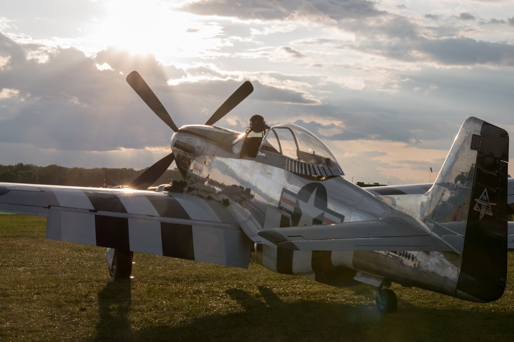 white and black plane on green grass field