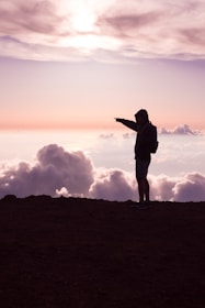 person standing on hill