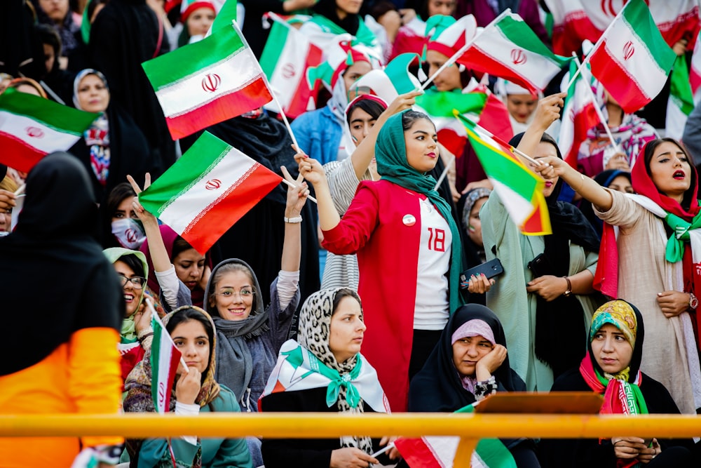 crowd of people holding mini flags