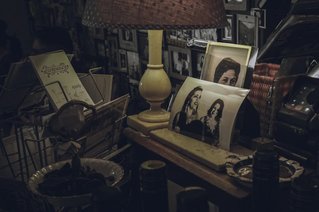 A warm gathering of elderly people sharing stories in a cozy living room filled with nostalgic electric memorabilia.