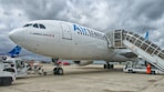 white and blue Air Trans landing during daytime