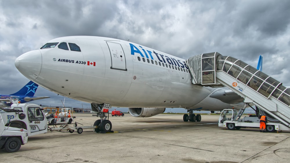 white and blue Air Trans landing during daytime