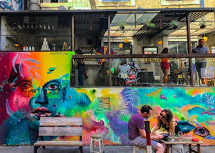 Photo of a vibrant mural painted on a cozy café wall.