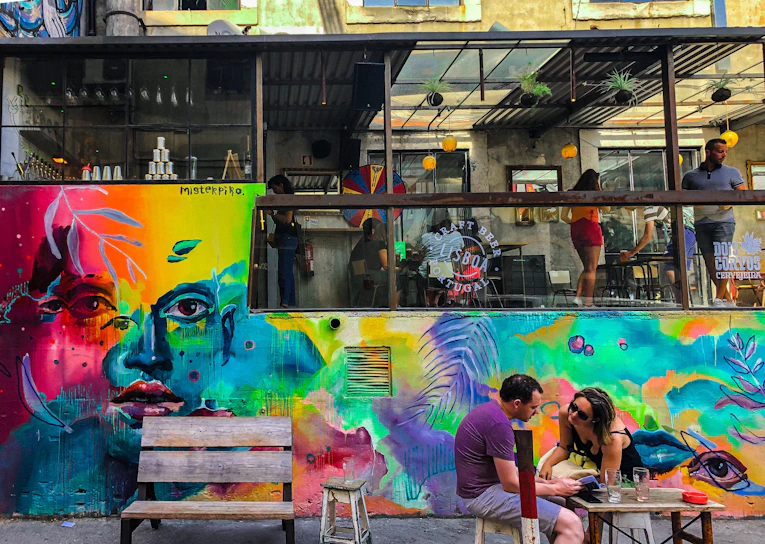 A vibrant mural featuring bold colors and dynamic shapes on a cafe wall in Delhi NCR.