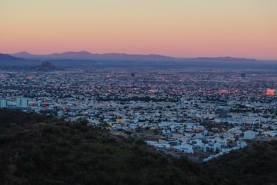 A panoramic view of a sunrise over an African city skyline, representing new opportunities and development.