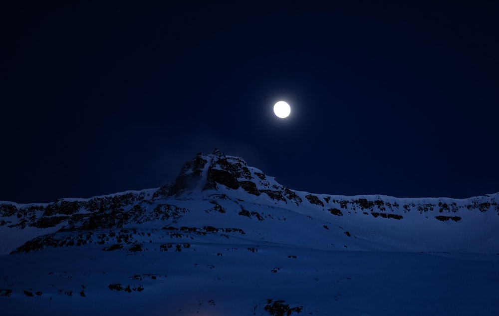 mountain covered with snow during night time