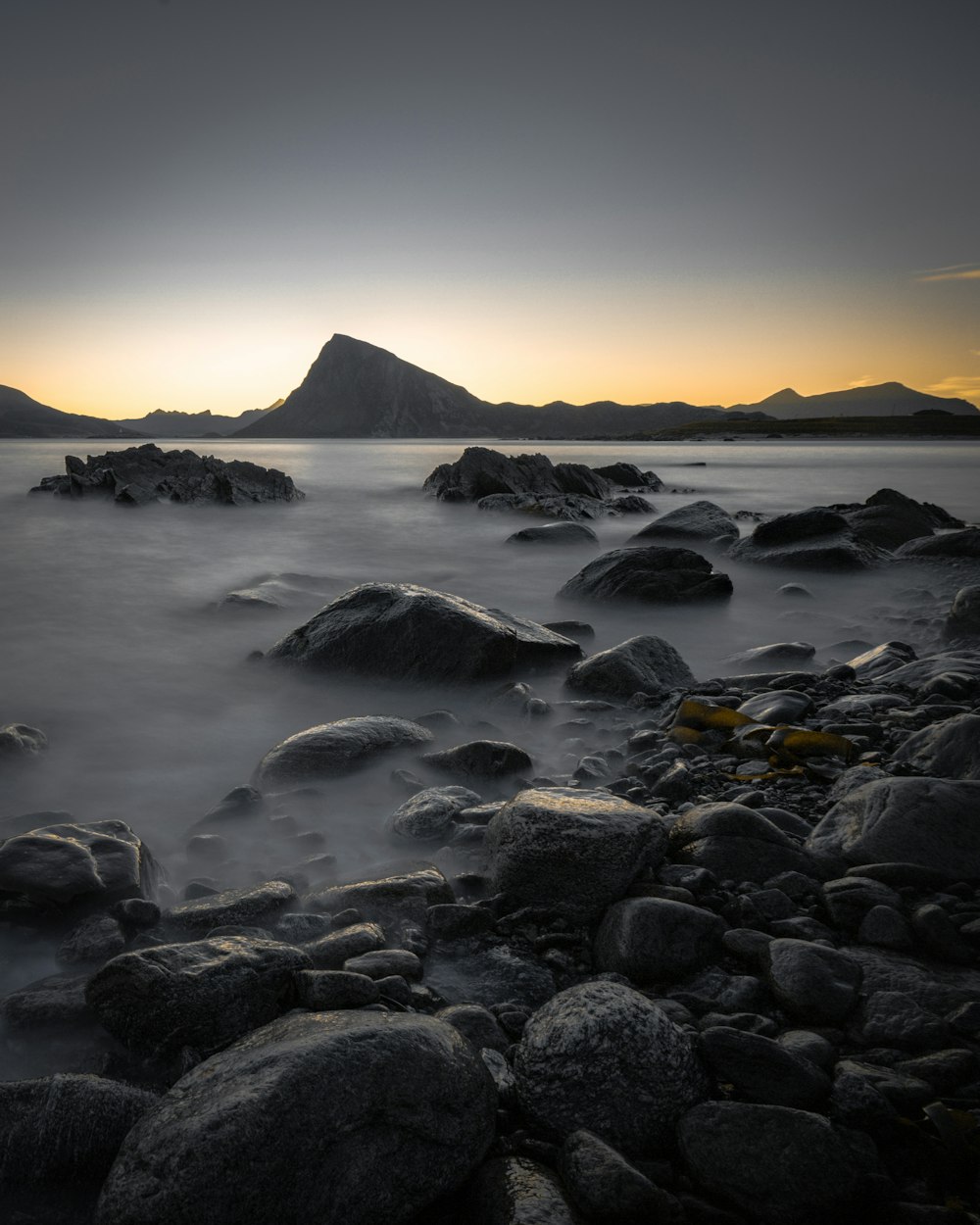 body of water and rocks during daytime