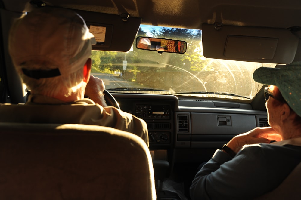 man and woman sitting on car front seat