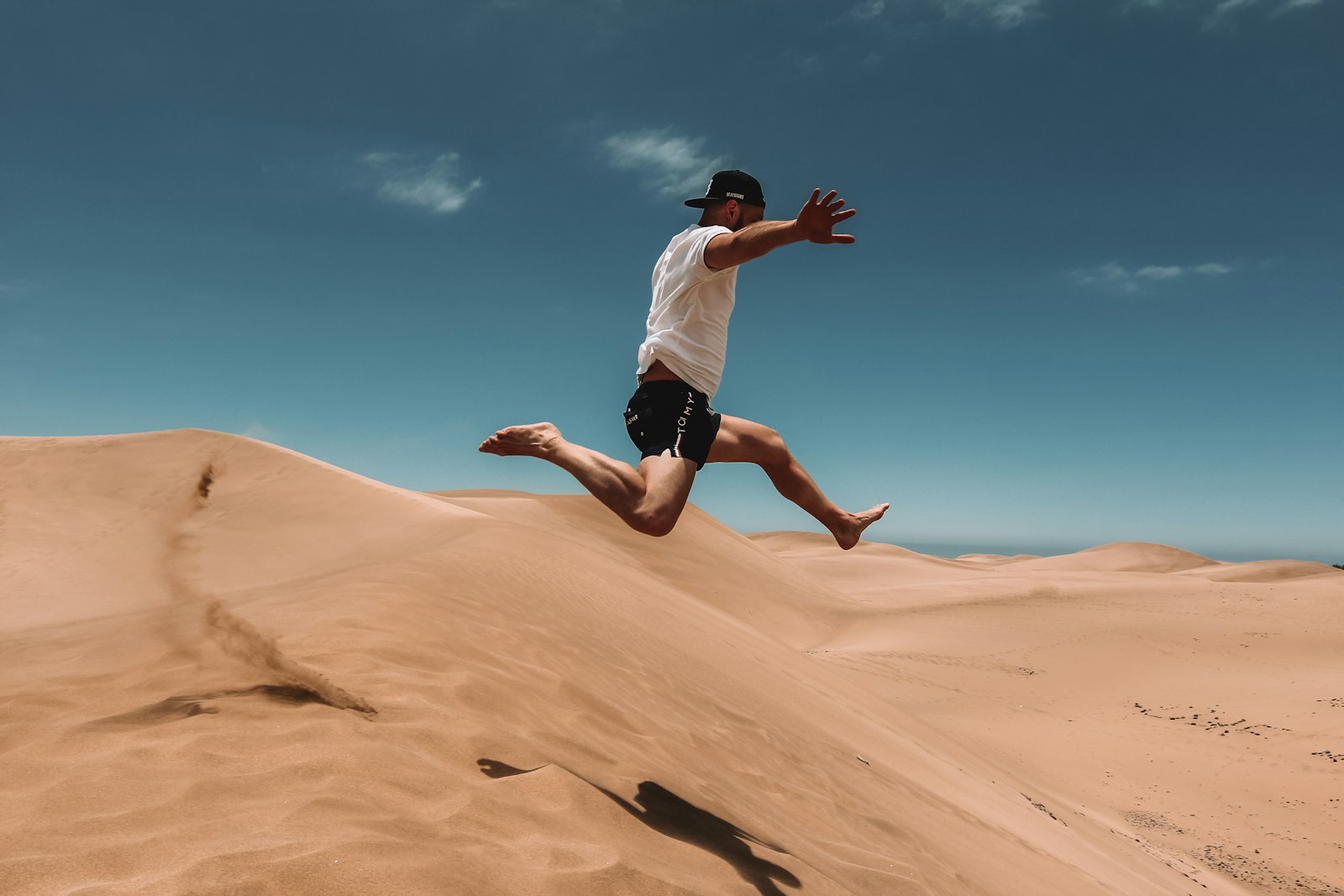 Tokina AT-X 11-20 F2.8 PRO DX Aspherical 11-20mm f/2.8 sample photo. Man jumping on desert photography