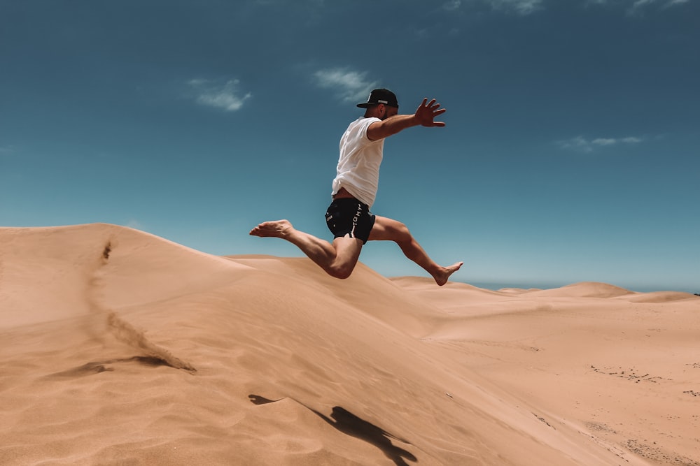 man jumping on desert
