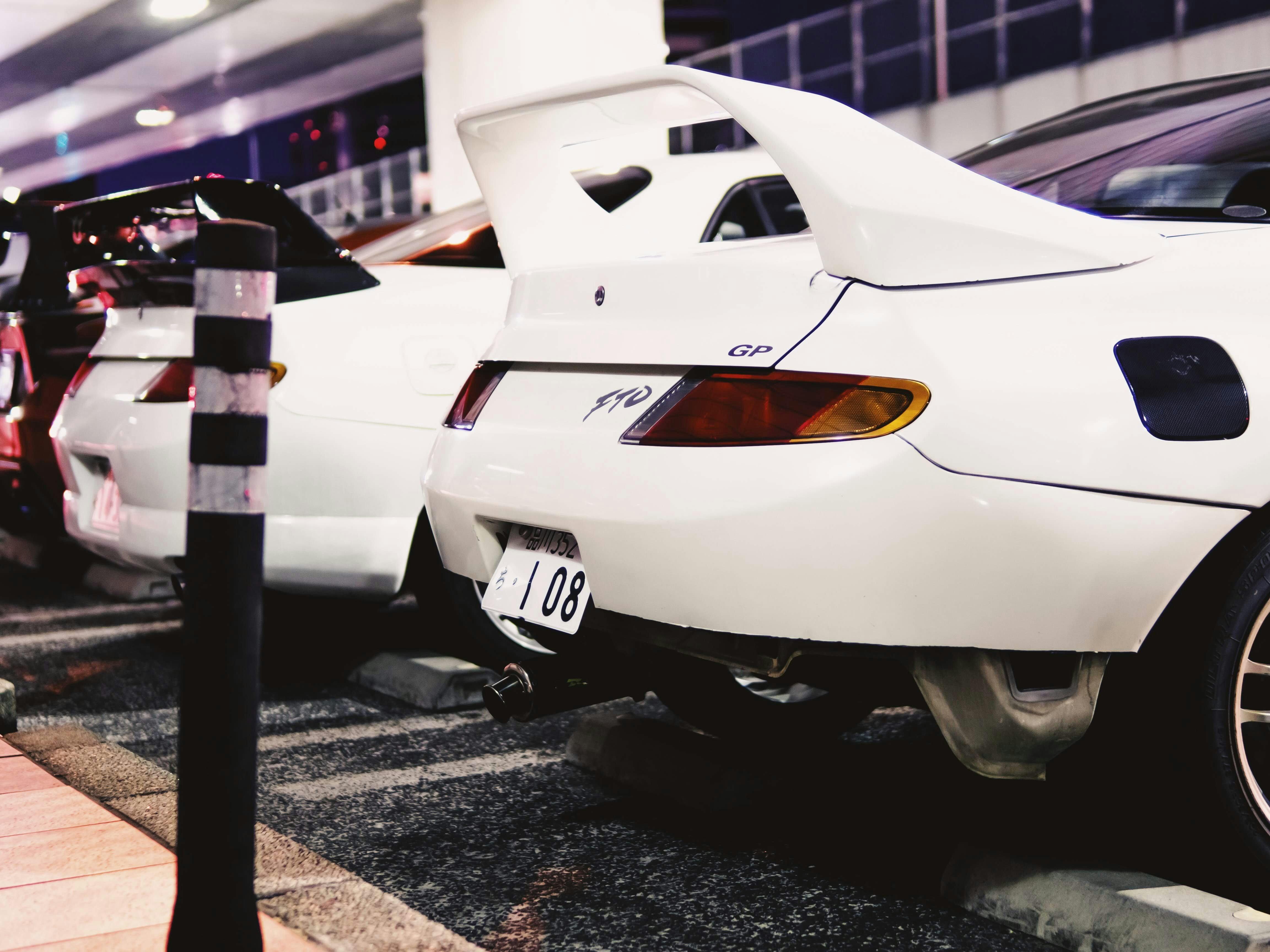 white car with 108 license mitsubishi teams background