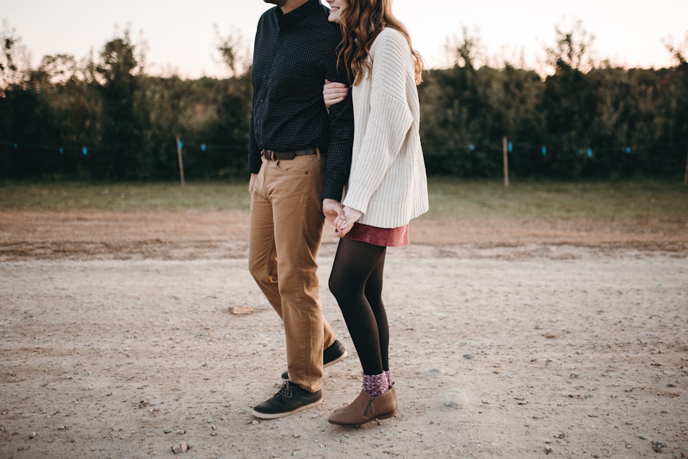 woman and man standing on road