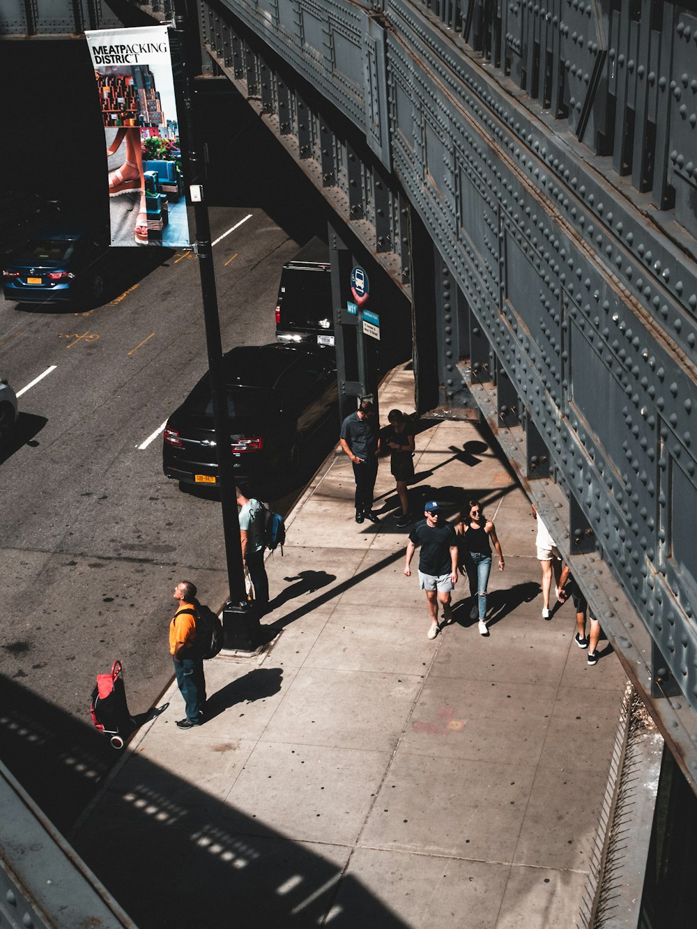 people walking under bridge