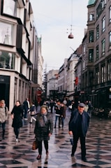 A busy urban street with newly paved concrete sidewalks.
