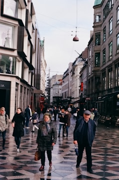 A busy urban street with newly paved concrete sidewalks.