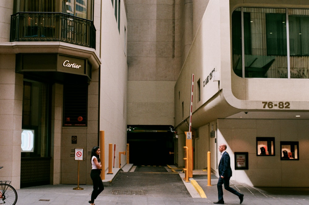 people walking beside concrete buildings during daytime