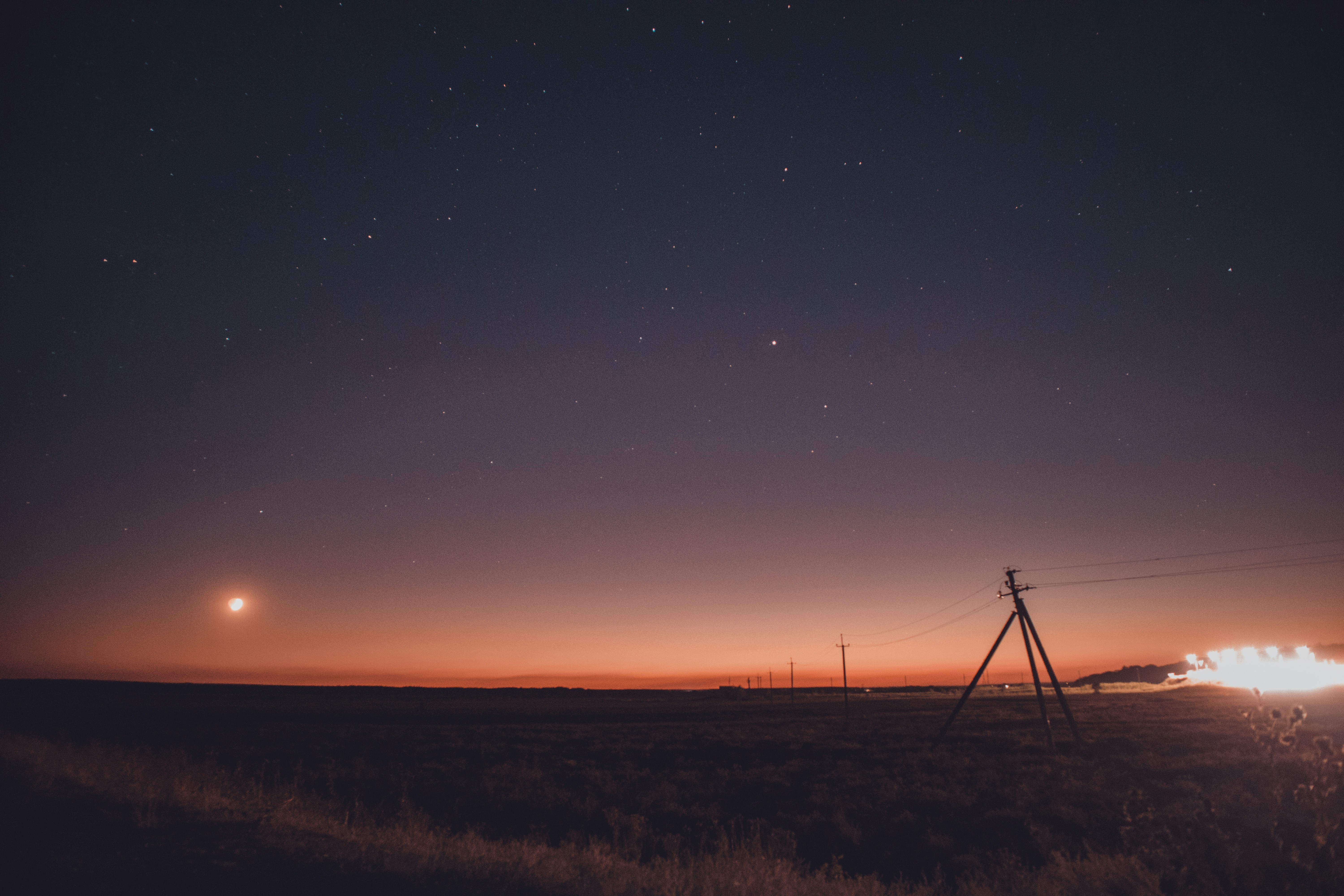 grass field with electrical posts with wires