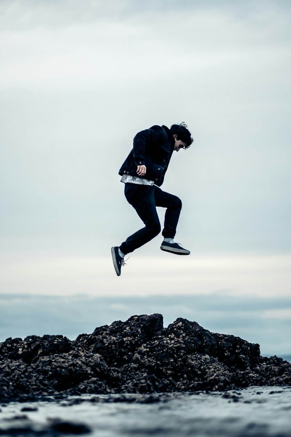 jumped man above rocky shore