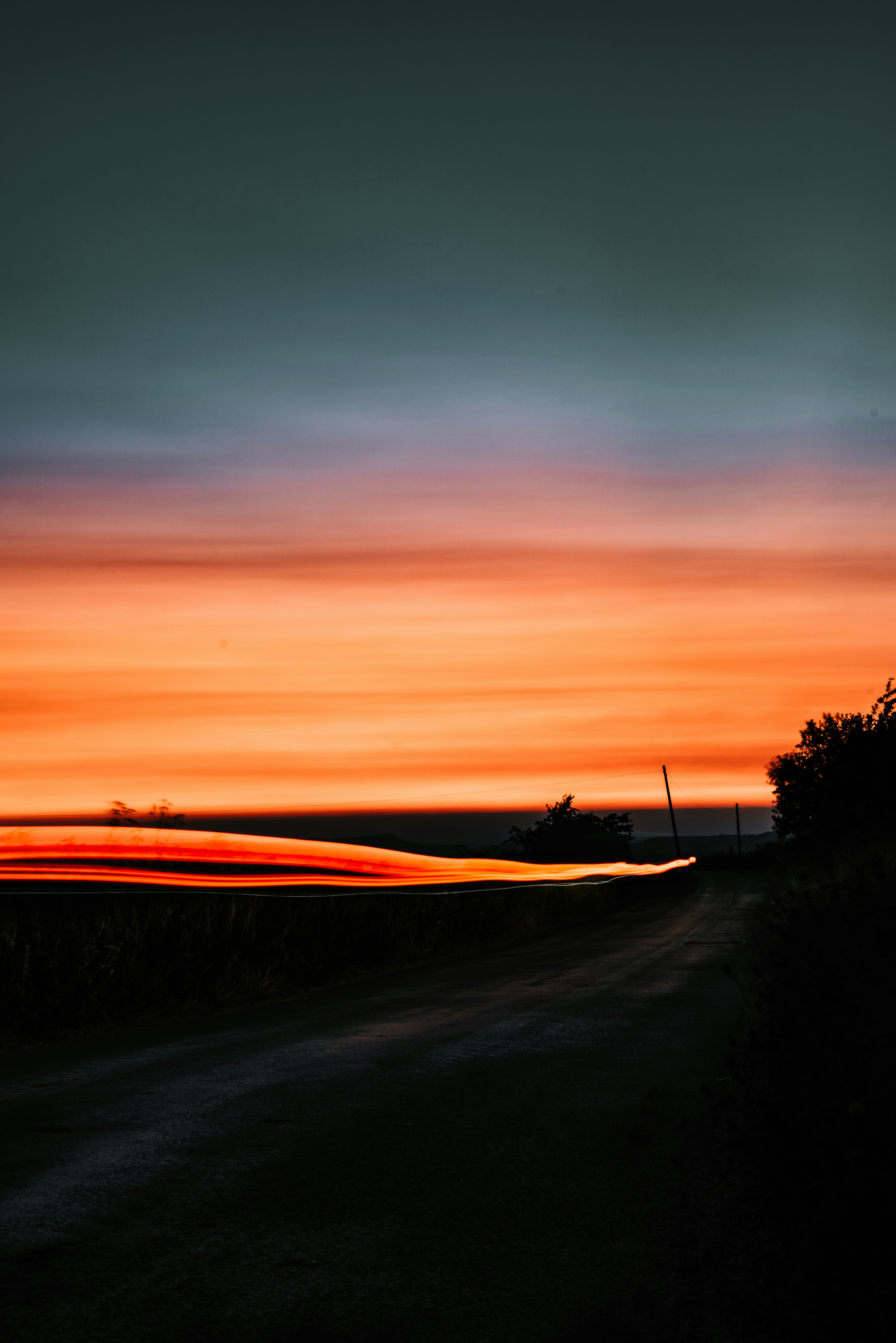 a road with a sunset in the background